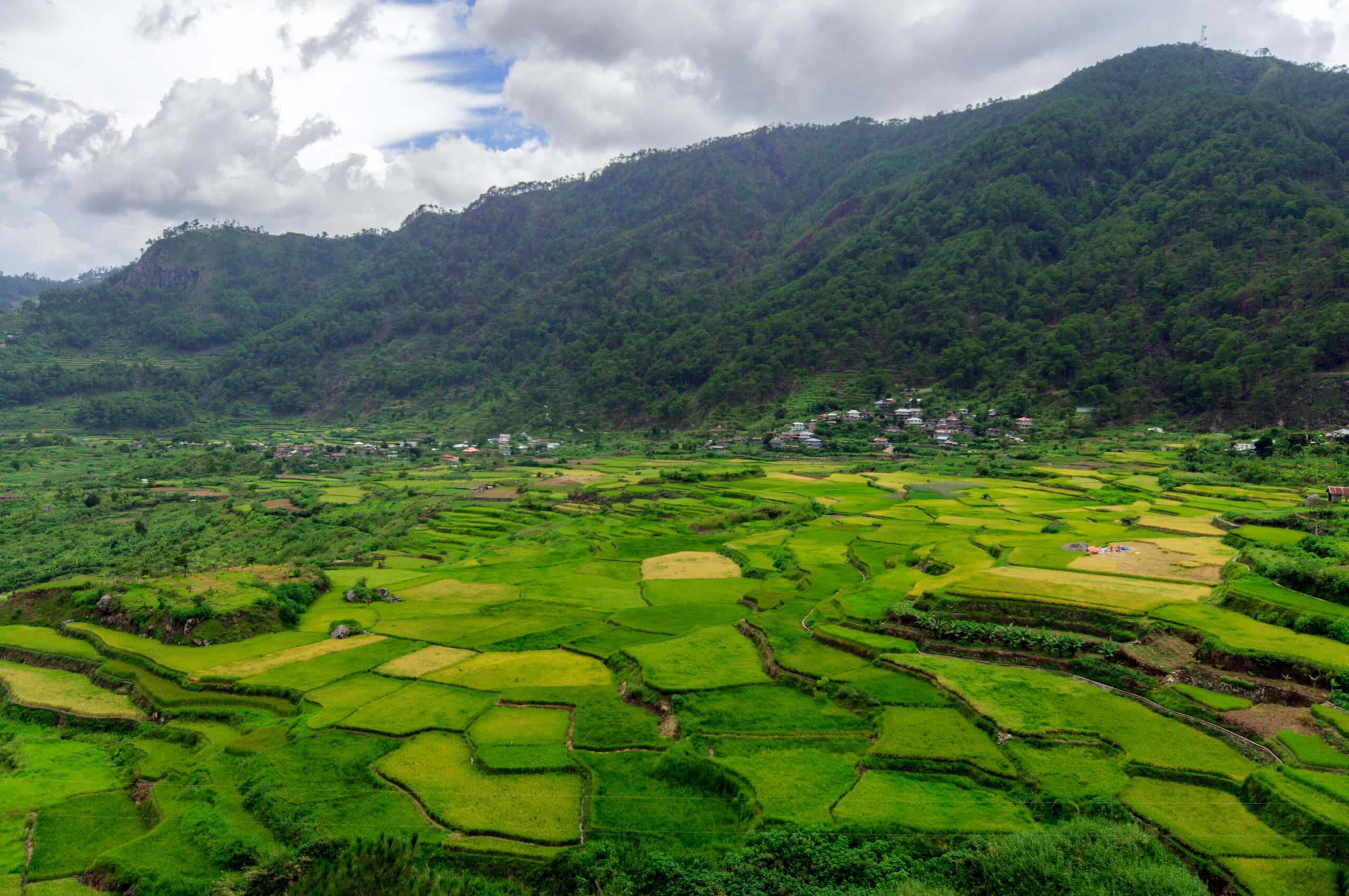 An aerial shot of a beautiful green landscape with high mountains in Sagada, Philippines