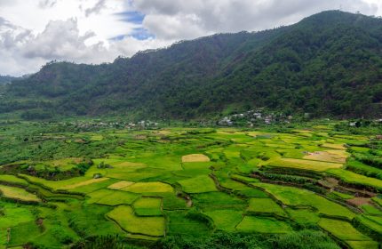 An aerial shot of a beautiful green landscape with high mountains in Sagada, Philippines